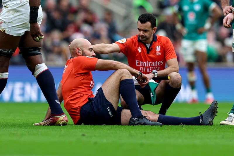 Assistant referee Pierre Brousset checks in with referee Andrea Piardi after he picked up a injury on Saturday. Photograph: Billy Stickland/Inpho