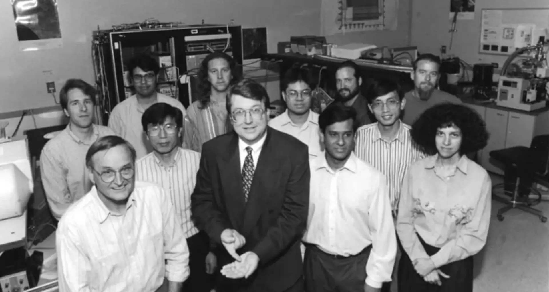 A group of people standing in a lab surrounded by technical equipment.