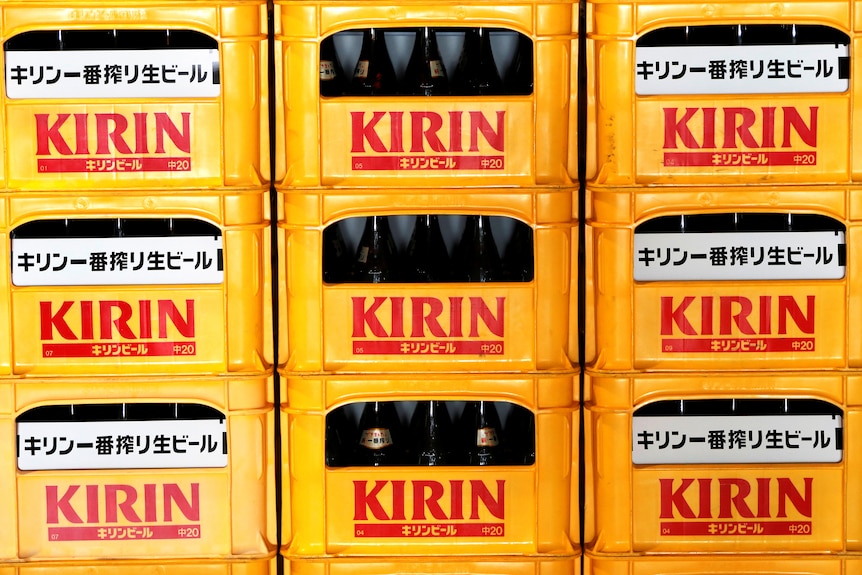 Plastic crates containing Kirin brand beer bottles are seen at its brewery in Yokohama