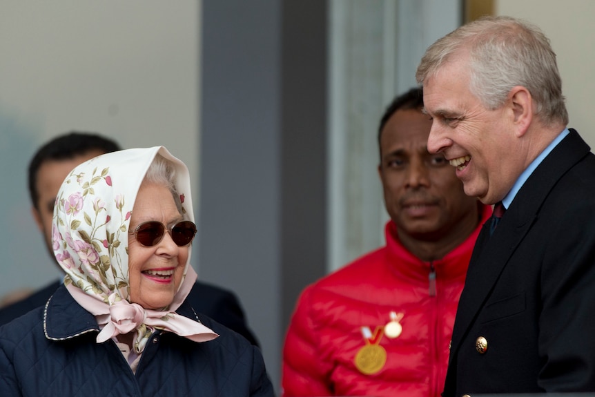 Queen in a headscarf and sunnies laughs with a Andrew in a suit.