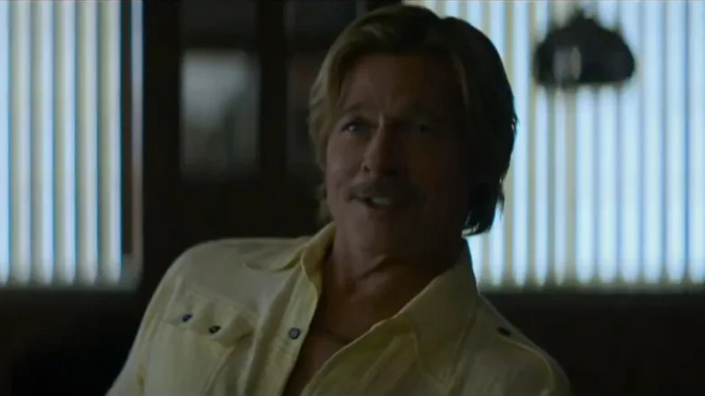 Cliff smiling in a yellow shirt in The Adventures of Cliff Booth