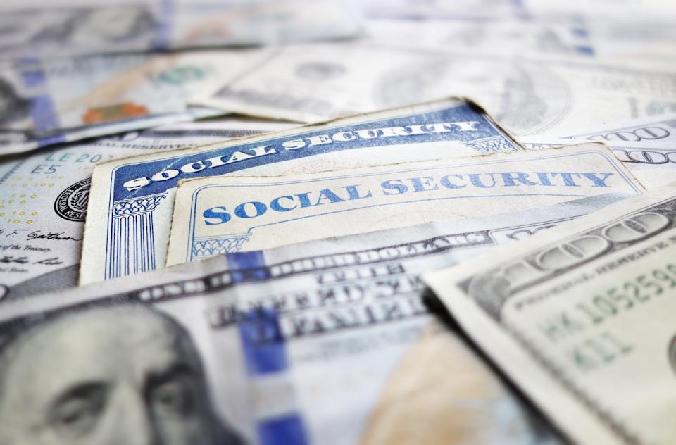 Social Security cards with hundred dollar bills.