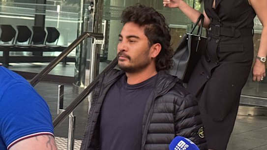 Tech billionaire Laurence Escalante (centre, in black) leaves court on Friday.