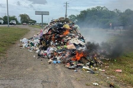 A load of dumped garbage on fire. 