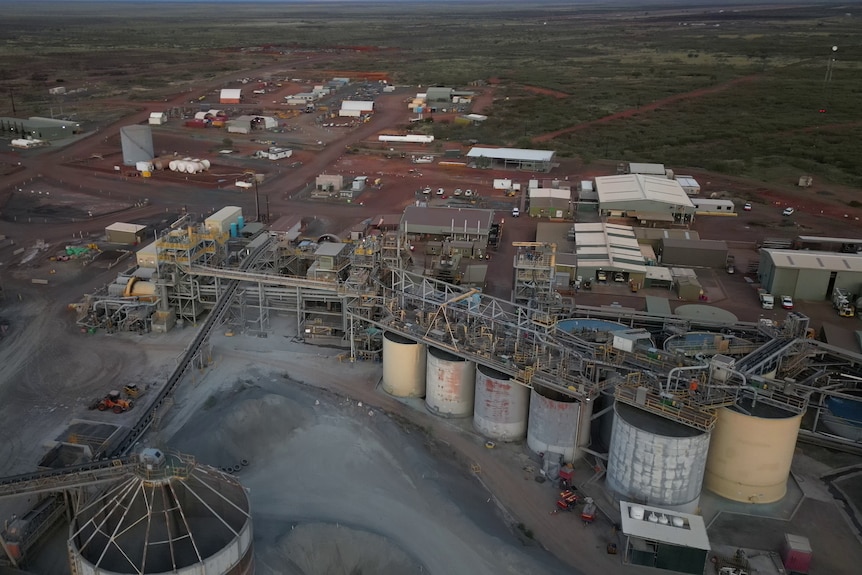 Industrial mine equipment towers over an otherwise empty desert landscape.
