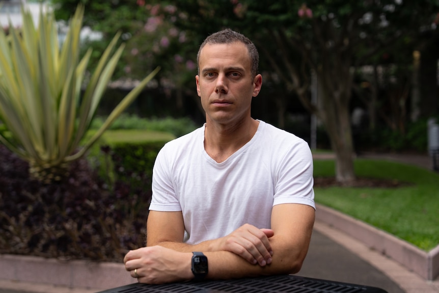 Simon Sawday stands outside in a garden and looks at the camera