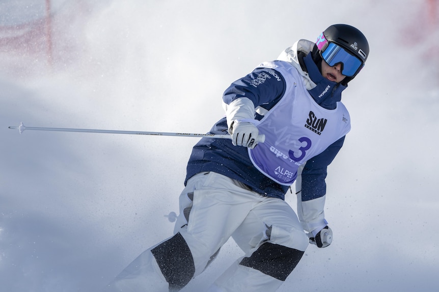 Jakara Anthony competing in the duel moguls, going down the mountain, turning to her left