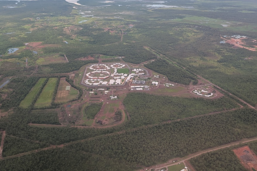 A wide shot showing the aerial view of a prison, which is surrounded by woodlands.