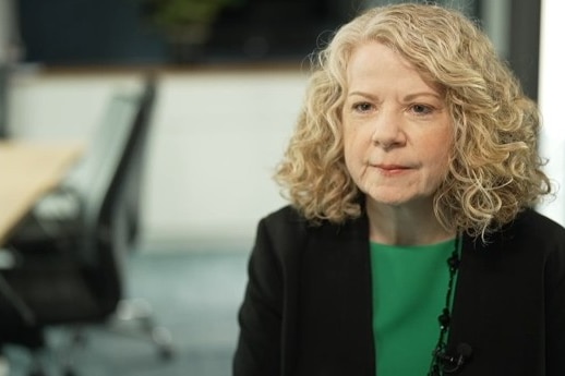 A woman with blond hair, Ruth Owen, in an office.