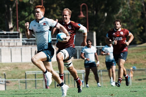 Sid Harvey races away from the Reds’ defence to score for the Waratahs in a trial game at Ballymore.