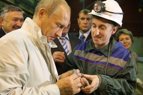 Russian Prime Minister Vladimir Putin examines an uncut chunk of diamond during a visit to Siberia.