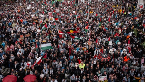 Thousands march across Sydney Harbour Bridge in one of biggest protests in city’s history – video