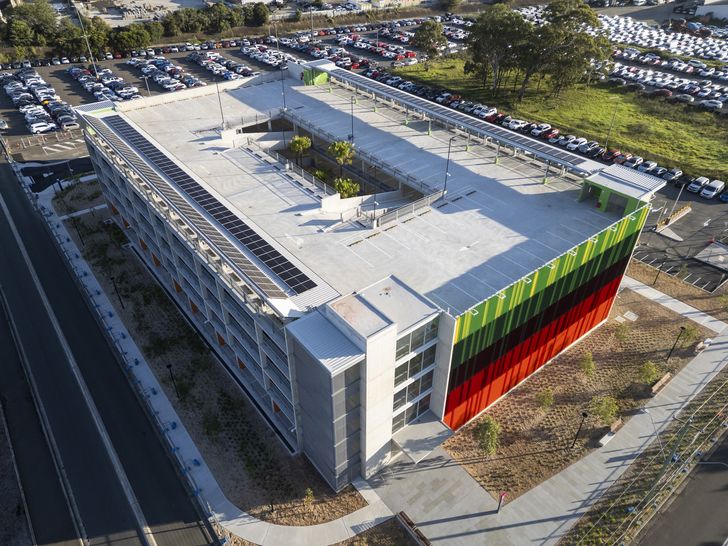 The centre of the building is open to the sky and filled with palm trees.