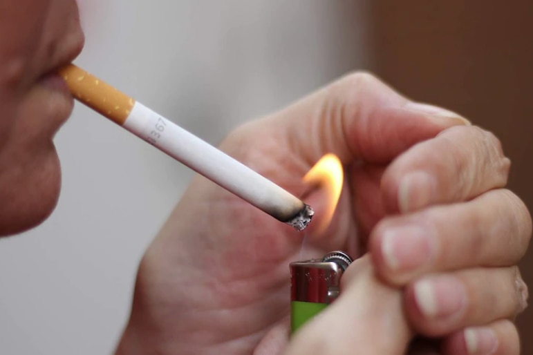Close of a person lighting a cigarette