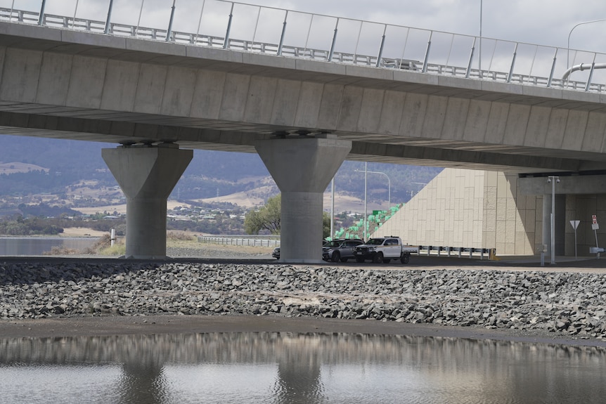 Image of a large concrete bridge which passes over a river.