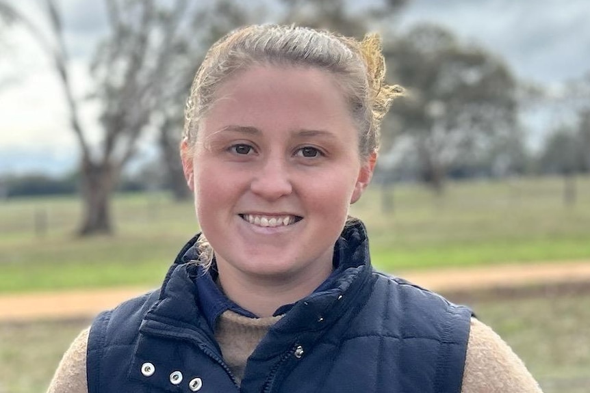 Two people standing in a paddock