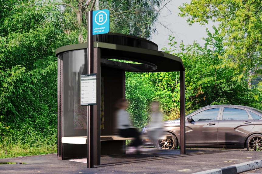 A smaller bus stop with a skylight and bench beside a road with two people sitting on it.