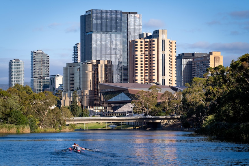 A series of buildings with a river in front