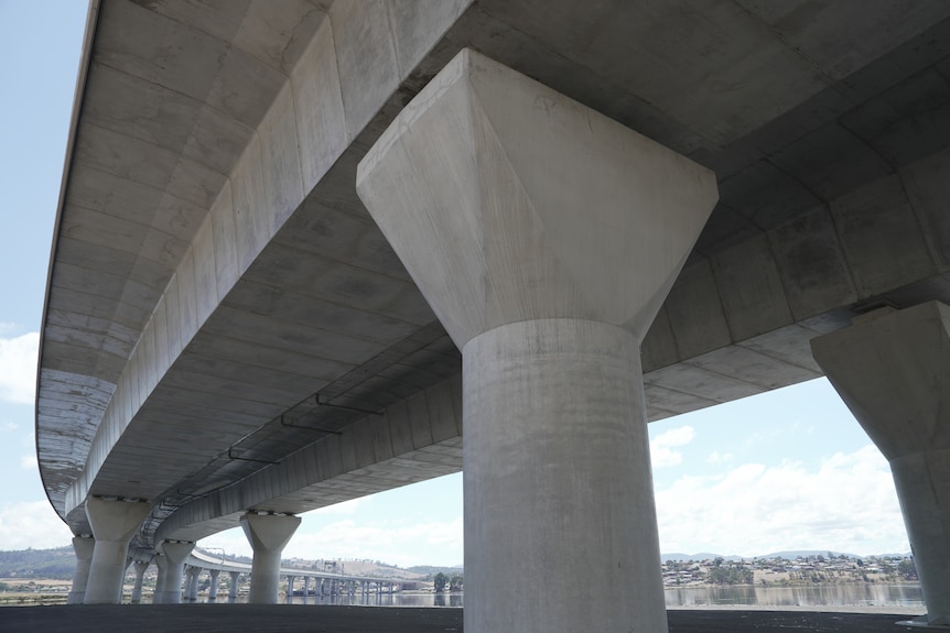 Image of a large concrete bridge which passes over a river.