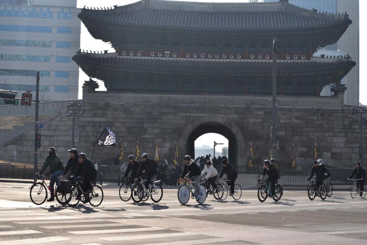 Cyclists ride past Namdaemun Gate during a Critical Mass ride in Seoul, Jan. 17. Courtesy of Bereket Alemayehu