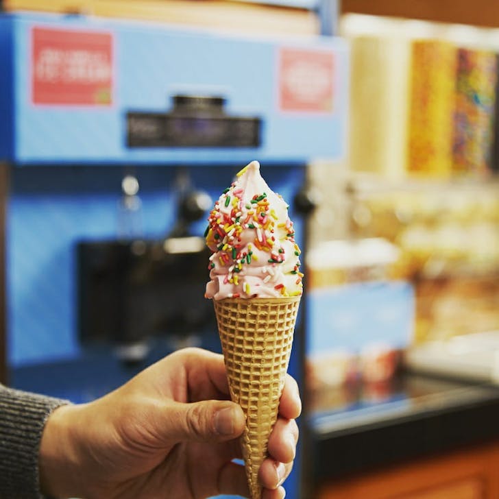 soft serve in a cone being held