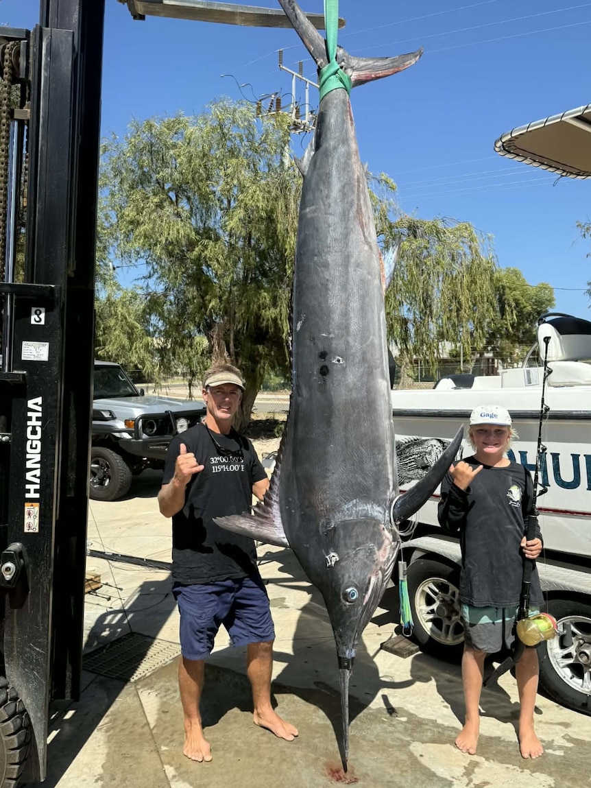 Father and son with the giant marlin