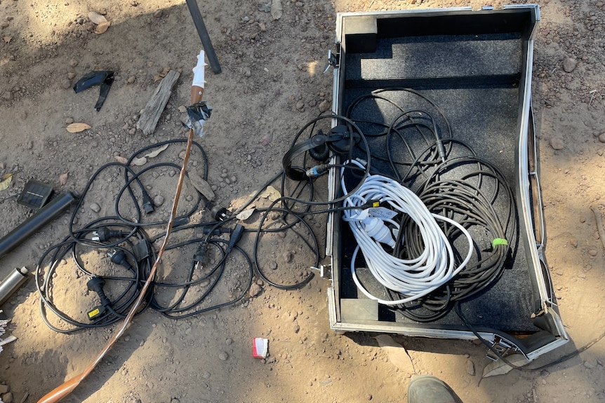 Electrical cords left strewn on the ground.