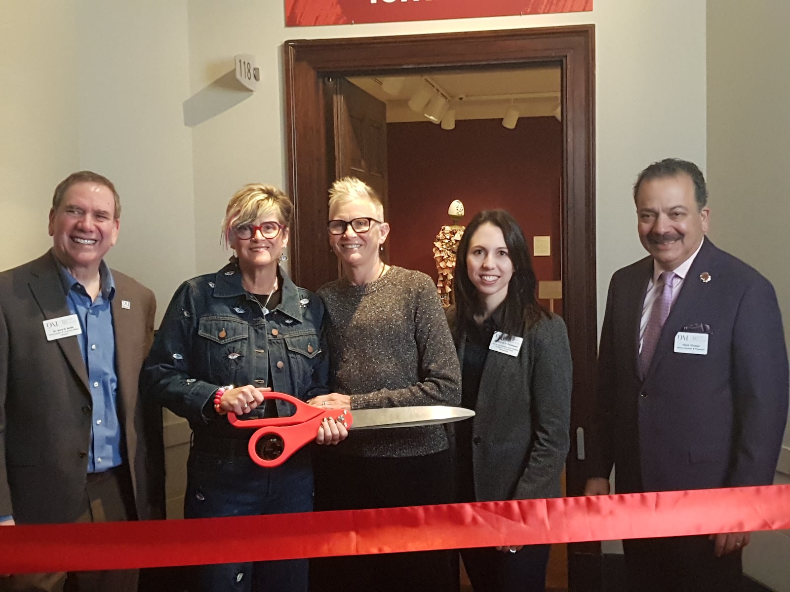 Sara M. and Michelle Vance Waddell (center) are seen Feb. 7, 2026 in front of the new art gallery at Dayton Art Institute that bears their names. Next to them are Jerry Smith, DAI's head curator (left) and Dr. Mariah Postlewait and Mark Shaker, the DAI's interim director and president on the right. ISMAEL MUJAHID/CONTRIBUTED