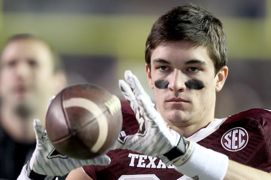 Boone Niederhofer catches a football before a Texas A&M game.
