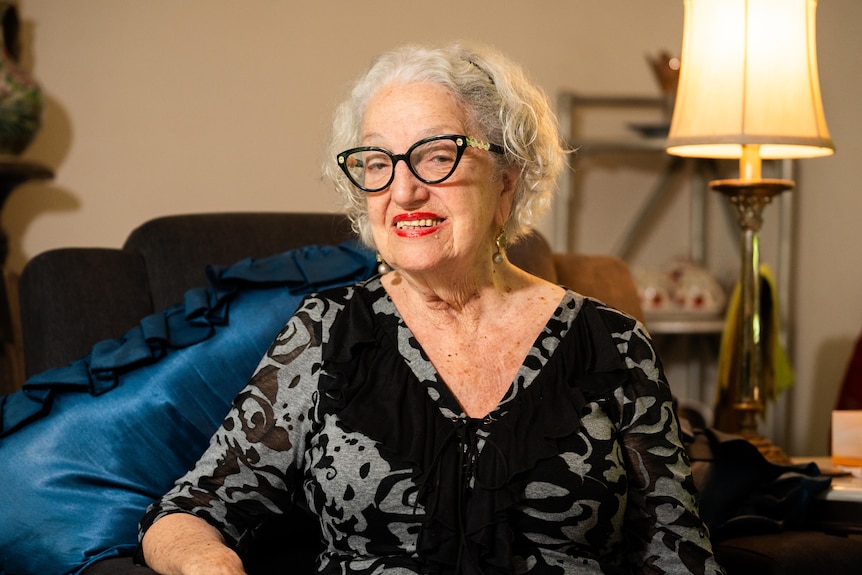 A woman sits in a chair.