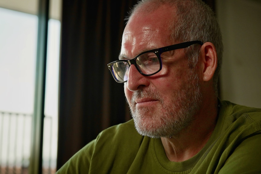 A close up of a man looking emotional. 