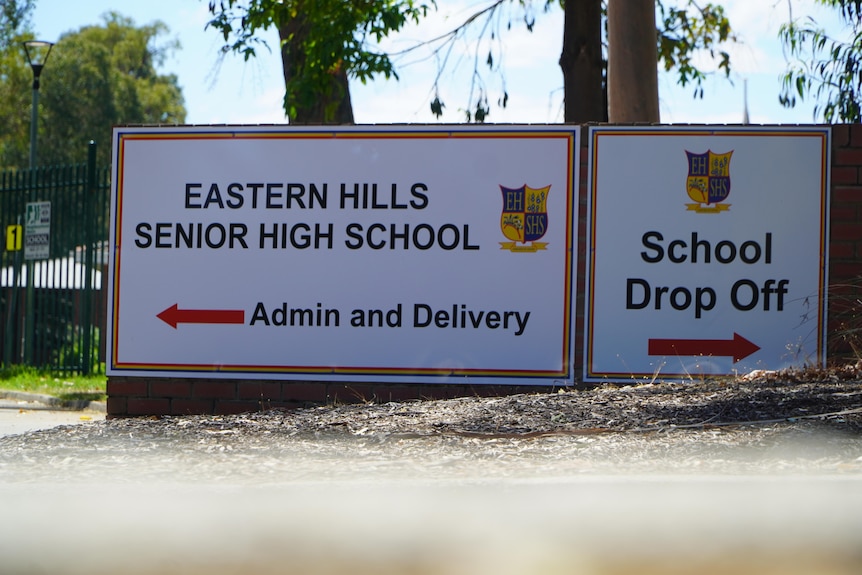 Two signs, one which says Eastern Hills Senior High School and the other which says 'school drop off'.