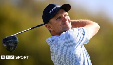 Justin Rose is presented the Championship trophy after winning the Farmers Insurance Open