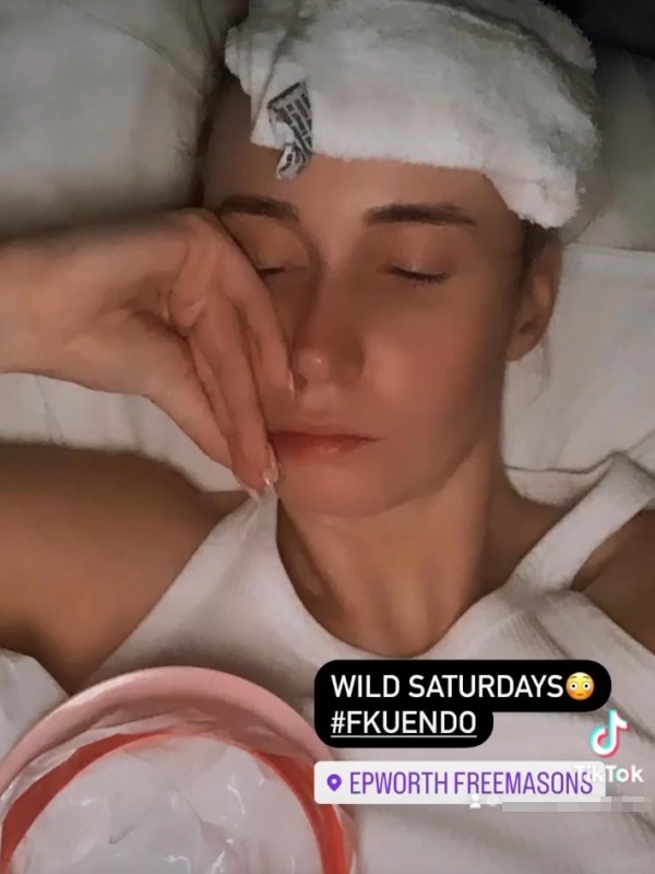 A screenshot of a post of a woman with eyes closed and a towel on her head. A vomit bag can be seen. The caption says '#FKUENDO'