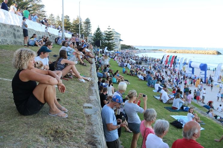 People line the grass areas at Cottesloe beach to watch the start of the Rottnest channel swim.
