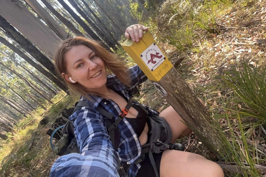 A woman kneeling in the bush