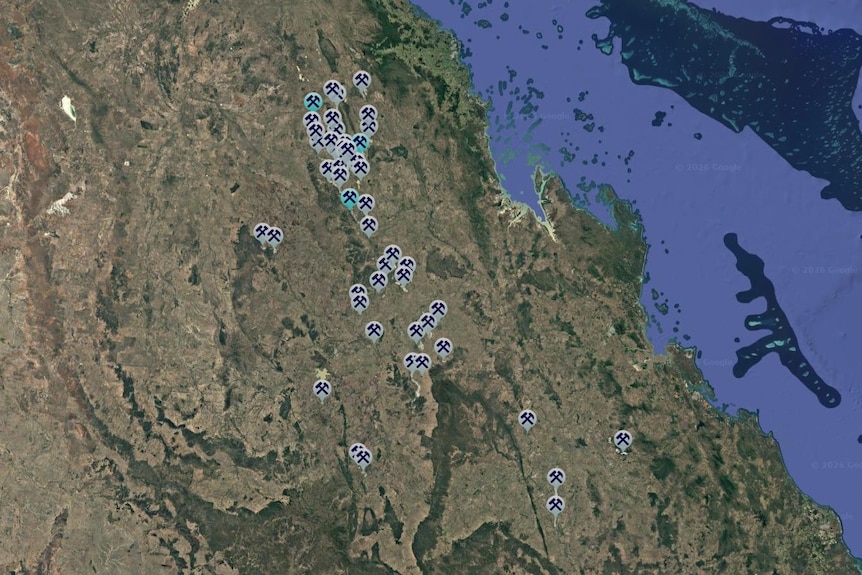A map with small tear shapes with mining symbols on them, some in grey and some in green. 