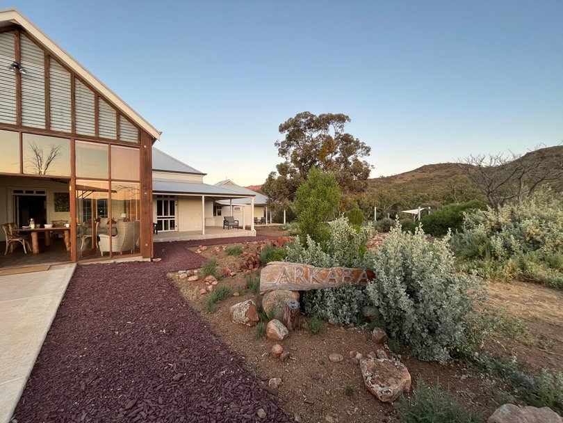 Vineyards fade. Red dirt begins.