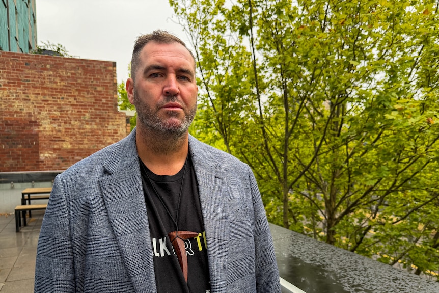 A man wearing a grey blazer.