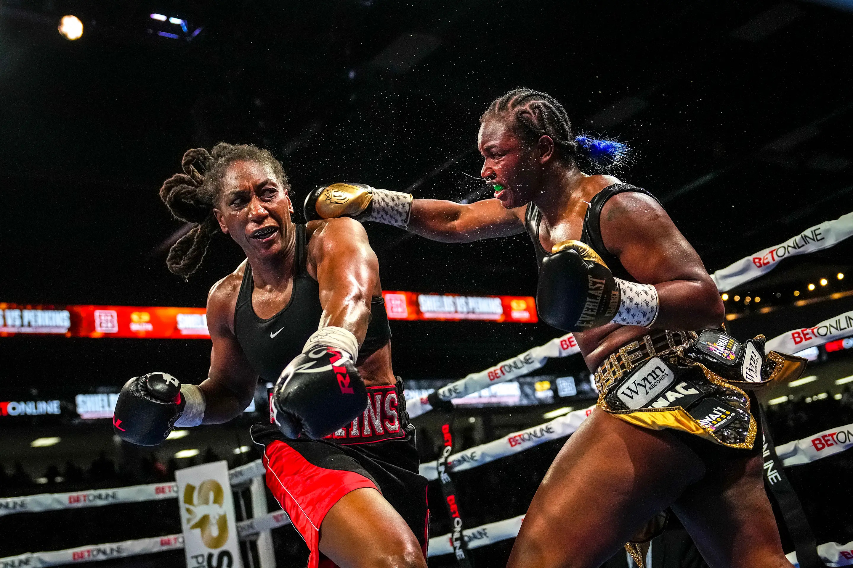 FLINT, MICHIGAN - FEBRUARY 02: Claressa Shields (R) punches Danielle Perkins during the ninth round of their undisputed heavyweight title bout on February 02, 2025 at Dort Financial Center in Flint, Michigan. (Photo by Nic Antaya/Getty Images)