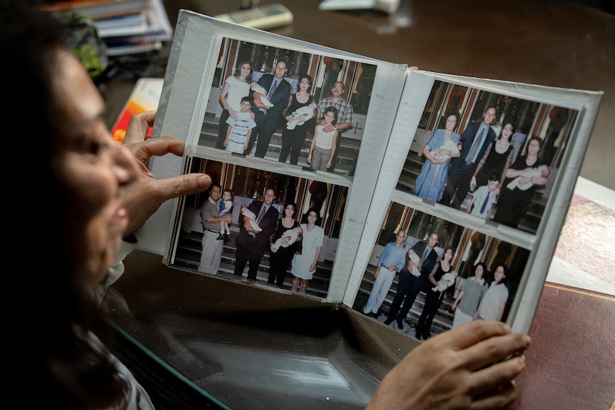 A woman flicking through a family photo album.