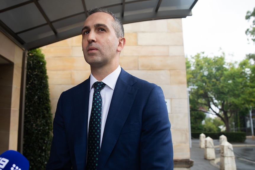 Daniel Pastorelli looks into the distance while standing outside a building.