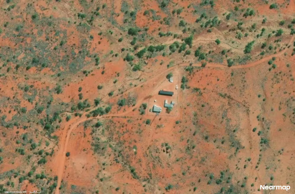 An aerial view of the Warramunga station shown as small buildings on a red desert landscape