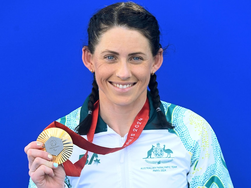 Woman holding gold medal