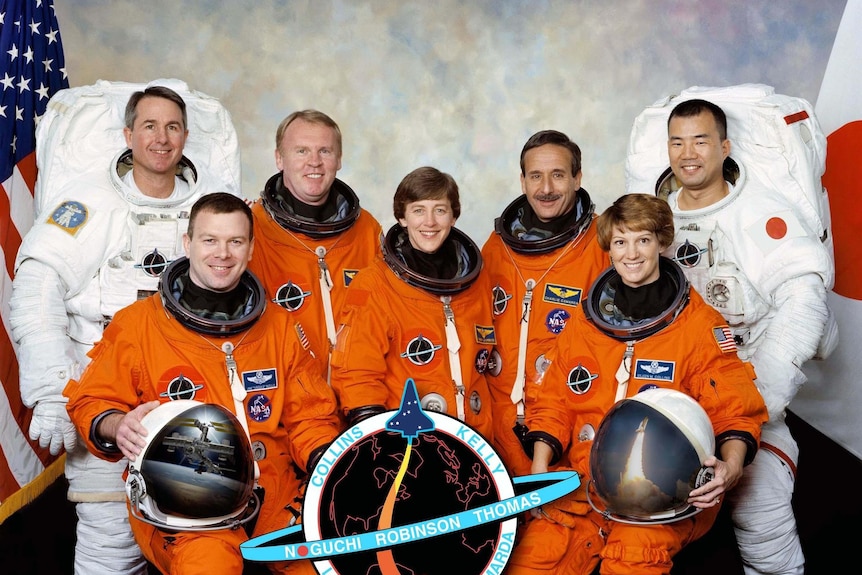 Seven astronauts in a crew portrait from 2004.