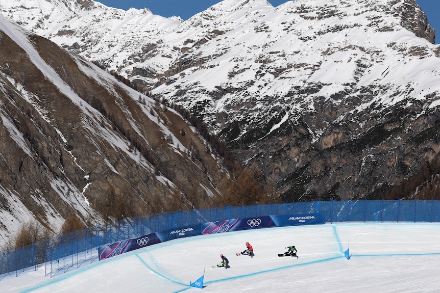 Snowboarders in front of a mountain