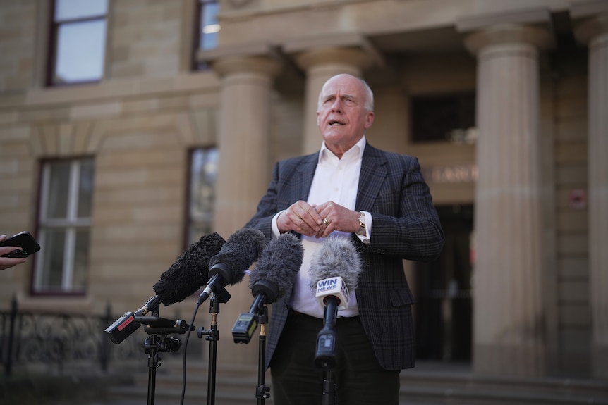 Eric Abetz talking at press conference outside Treasury Building.