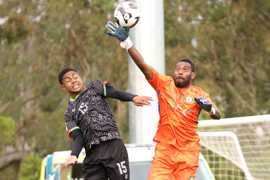 Philip Mango defends a shot on goal during a match.
