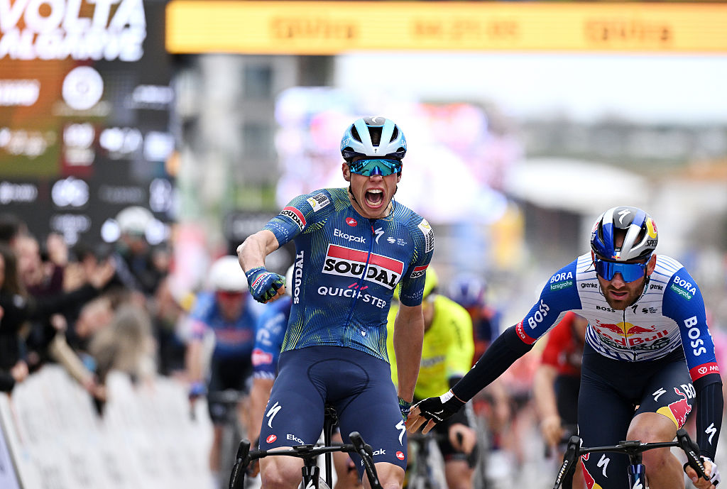 TAVIRA, PORTUGAL - FEBRUARY 18: (L-R) Paul Magnier of France and Team Soudal Quick-Step celebrates at finish line as stage winner ahead of Jordi Meeus of Belgium and Team Red Bull - BORA - hansgrohe during the 52nd Volta ao Algarve em Bicicleta 2026 - Stage 1 a 183.5km stage from Vila Real de Santo Antonio to Tavira on February 18, 2026 in Tavira, Portugal. (Photo by Dario Belingheri/Getty Images)