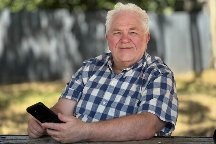A man wearing a check shirt.